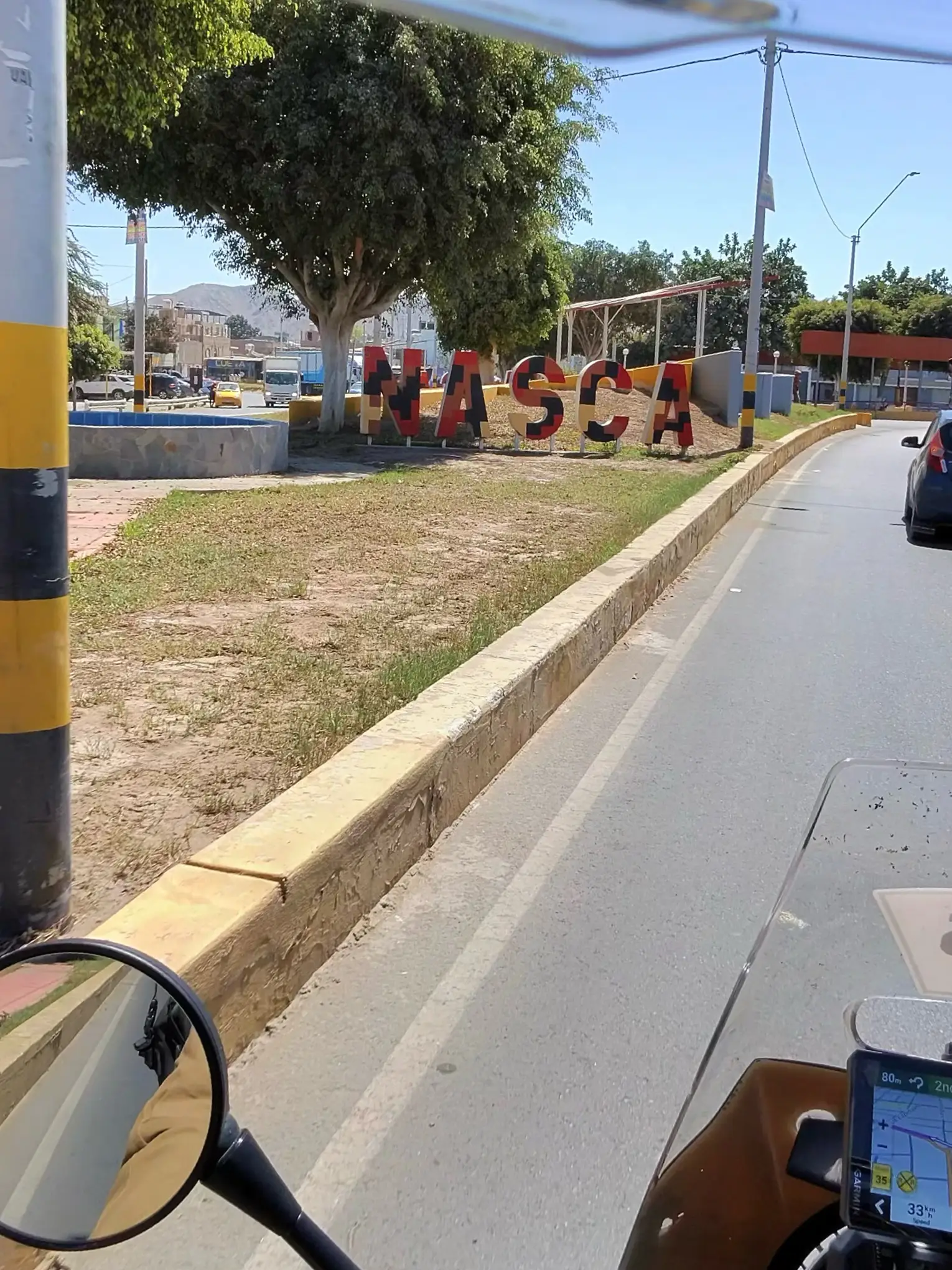 Entrance sign of Nasca city viewed from bike during motorcycle trip from Santa Cruz de la Sierra to Lima